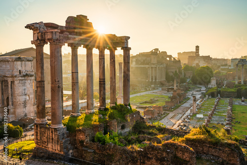 Roman forum ruins at sunrise in Rome with Inscription "Senatus Populusque Romanus incendio consumptum restituit" - The Senate and People of Rome restored what had been consumed by fire