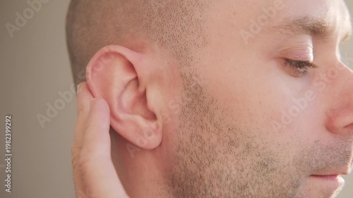 young man touching painful ear, discomfort and earache, healthcare problem, medical symptom acoustics Auditory System, Hearing Test, Cochlear implant, audiology support, ear health and deafness