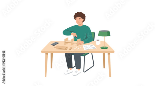 Man assembling wooden furniture model at desk with tools and manual