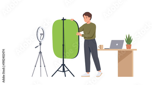 Man setting up green screen and ring light at home