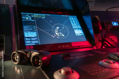 Bild auf Leinwand ECDIS maneuvering display with binoculars on ship bridge