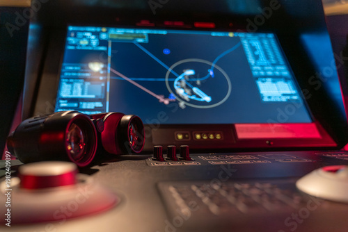 Close-up binoculars and ECDIS maneuvering track display on bridge