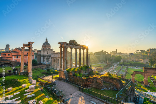 Roman forum ruins at sunrise in Rome with Inscription "Senatus Populusque Romanus incendio consumptum restituit" - The Senate and People of Rome restored what had been consumed by fire