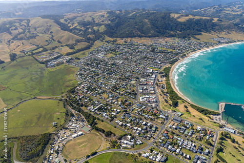Apollo Bay aerial view of coastal town, green hills and blue ocean