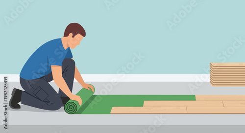 Worker installing floor underlayment and laying wood planks in a room with light blue walls
