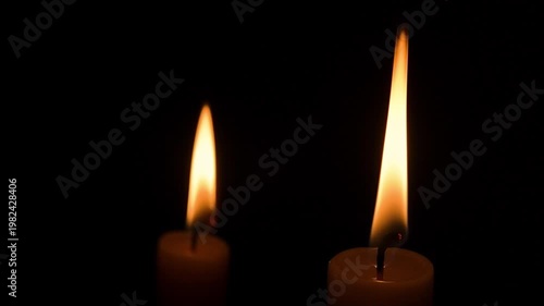 Two Burning Candles Close-Up on Black Background, Warm Flame Light, Minimal Dark Scene, Copy Space