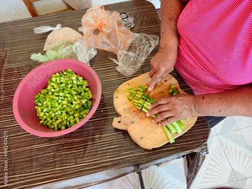 Woman Slicing Fresh Green Nopales on a Table