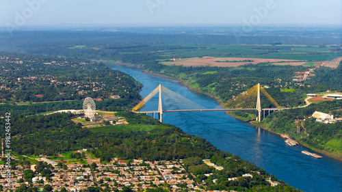 Foto Aerial close up of Integration Bridge and Ferris wheel over Parana River at Brazil Paraguay border