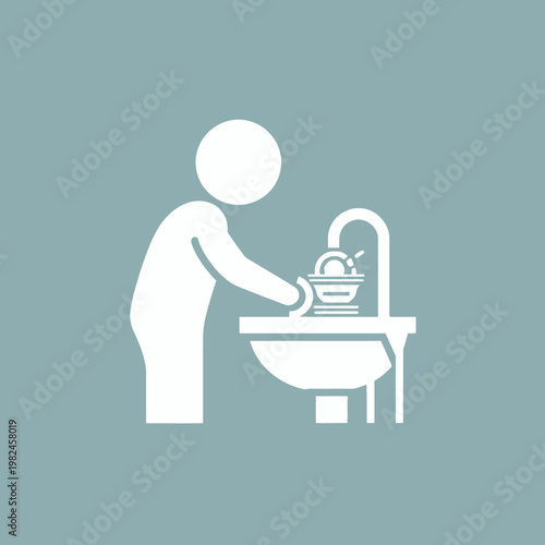 A person washes dishes at the sink