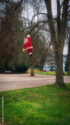 Santa Claus hanging on a tree in the park