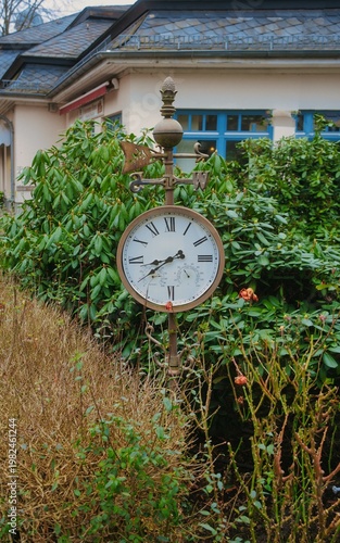 Classic bronze clock in the front garden
