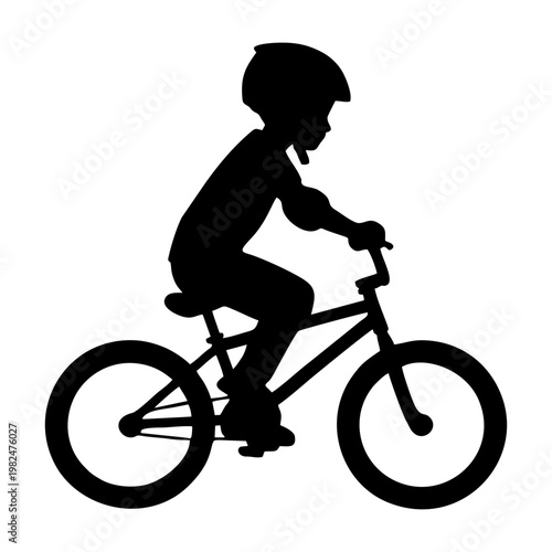 silhouette of a child riding a BMX bike with head protection and elbow protectors