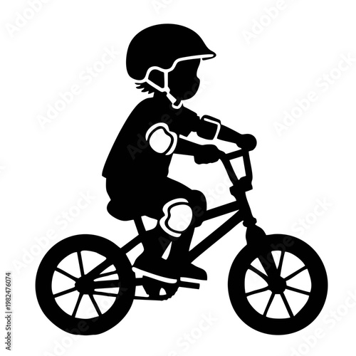 silhouette of a child riding a BMX bike with head protection and elbow protectors
