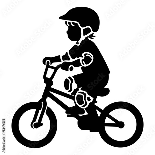 silhouette of a child riding a BMX bike with head protection and elbow protectors