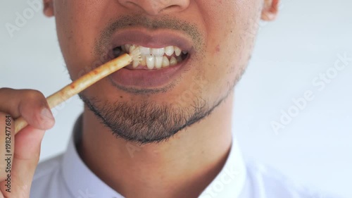 Man using miswak for traditional oral hygiene