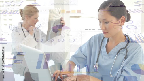 Nurse typing on laptop initiating medical charts sliding over doctor studying X-ray for diagnosis