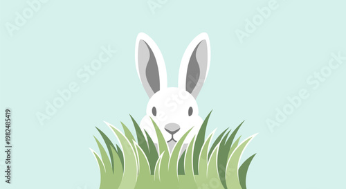 A cute white rabbit peeking out from green grass.