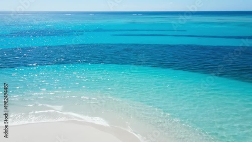 Aerial panorama of a curved white sandbar in pristine turquoise water, featuring transparent lagoon rings, clean tropical gradients, and a flawless horizon over an untouched island beach setting
