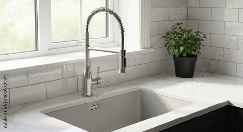 Modern kitchen sink with pull-down faucet and white subway tile backsplash.