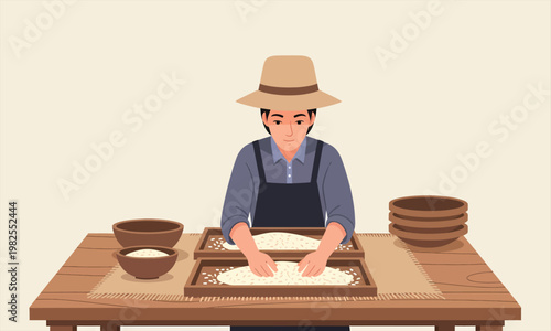 A person carefully preparing and sorting rice using traditional methods on a wooden tray