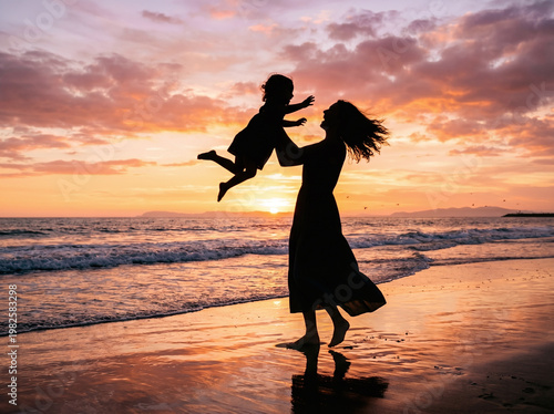 Silhouette of Mother Joyfully Lifting Child into the Air on a Beach at Sunset