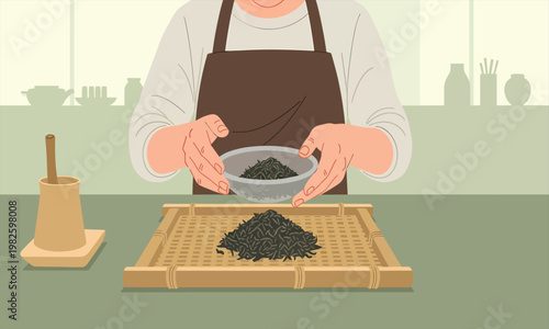A person carefully handling loose tea leaves, placing them onto a bamboo tray for drying
