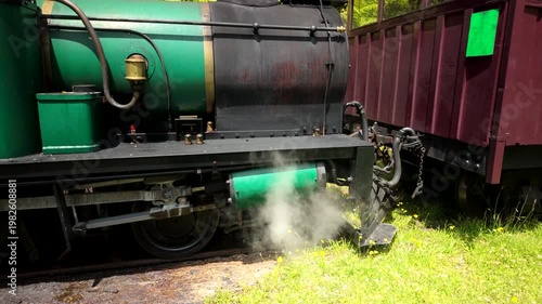 Steam Locomotive Releasing Vapor Beside Wagon