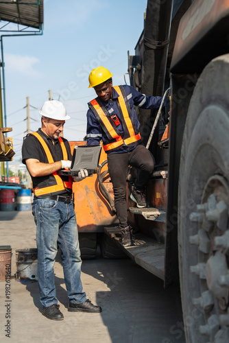 Construction workers collaborate on heavy machinery industrial site photo daylight close-up teamwork in action