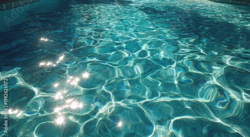 Sunlight dances across the surface of clear turquoise water, creating a mesmerizing pattern of shimmering reflections and vibrant hues.