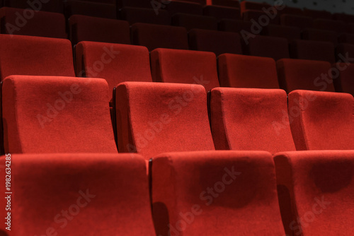Red empty seats in the theater auditorium
