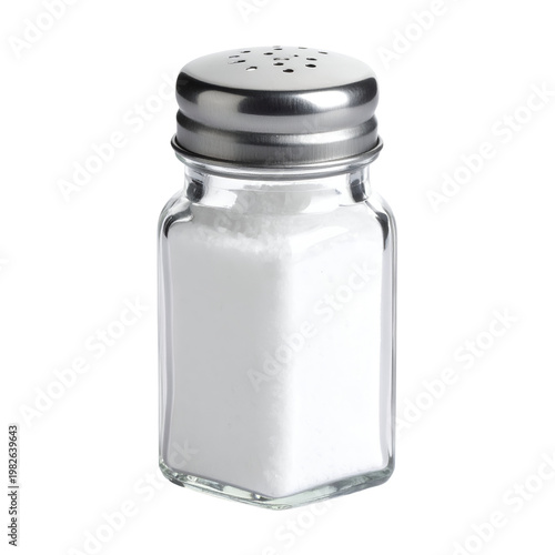 Glass salt shaker filled with white salt crystals, isolated on white background. Close-up of a square salt dispenser with metal lid and holes for seasoning.
