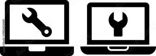 Two laptops displaying a wrench symbol indicating technical maintenance or repair tools