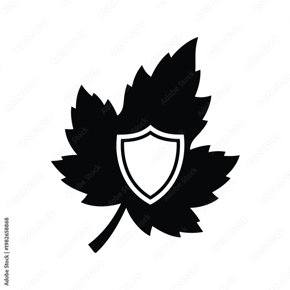 Obraz premium Black silhouette of a leaf with a white shield emblem in the center