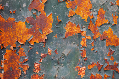 weathered green metal surface with heavy rust and peeling paint