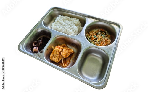A stainless steel food tray containing rice, vermicelli, tofu, and squid, isolated on a white background. Government's free nutritious food program.