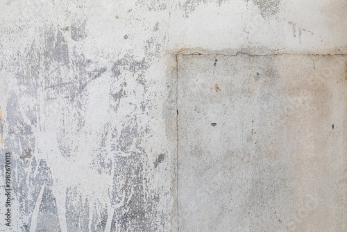 weathered white concrete wall with patch repair and grunge texture