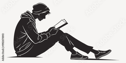 Profile silhouette of a young person wearing a beanie and hoodie sitting down and engrossed in reading a book with silhouette education learning knowledge literature academic lifestyle