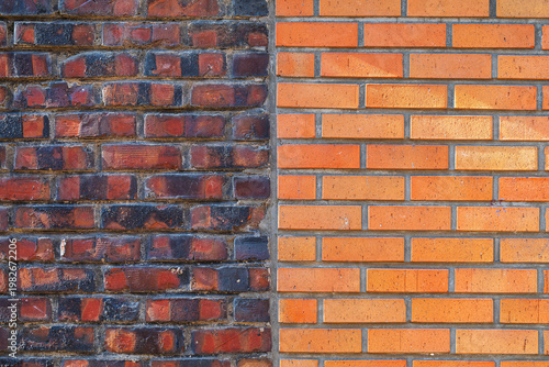 contrast between old weathered dark bricks and new orange brick wall