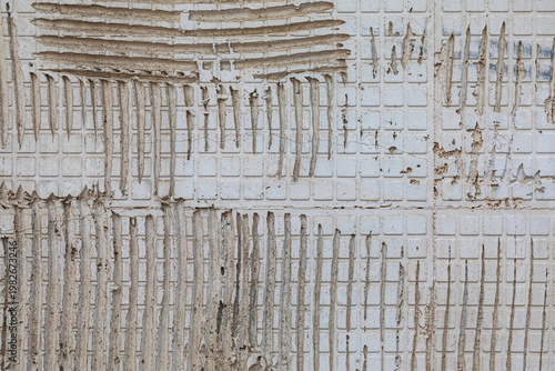 vintage industrial grunge background featuring removed tile texture and marks