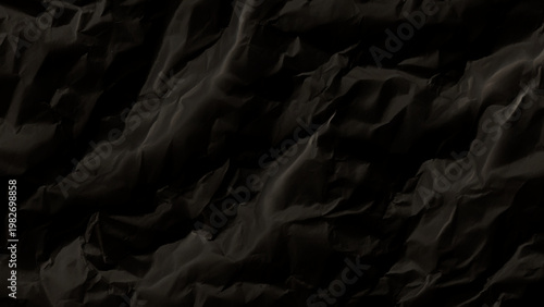 Crumpled black paper texture with deep folds and creases on surface