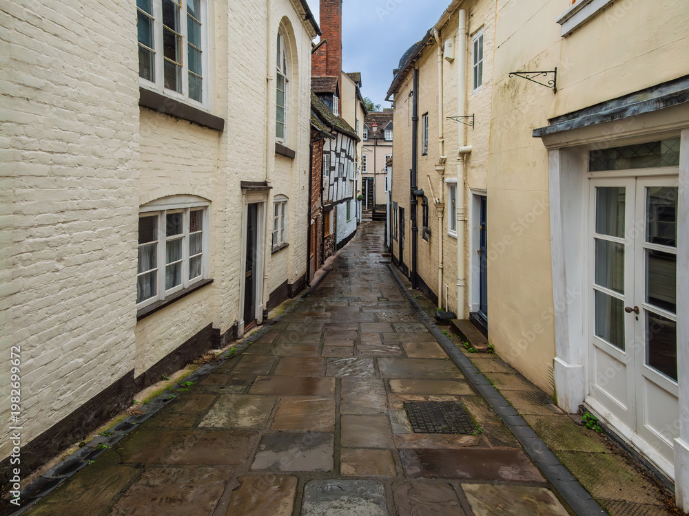 Fototapeta premium Ancient Narrow Flagstones Alley In The Rain