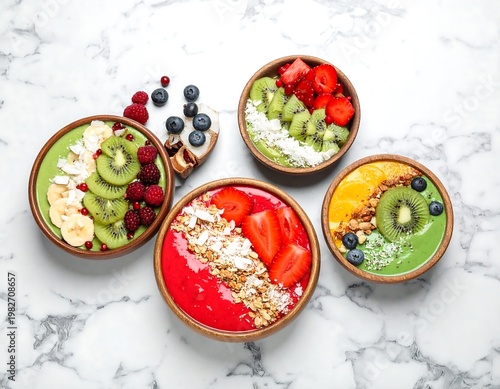 A vibrant and healthy arrangement of smoothie bowls with fresh fruits and toppings on a marble surface
