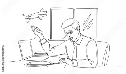 A man in a modern office working on a laptop with a drone flying above him