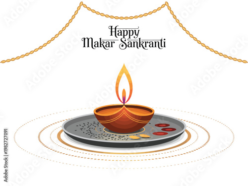 Diya lamp glows on a silver plate to mark the traditional Makar Sankranti harvest festival.