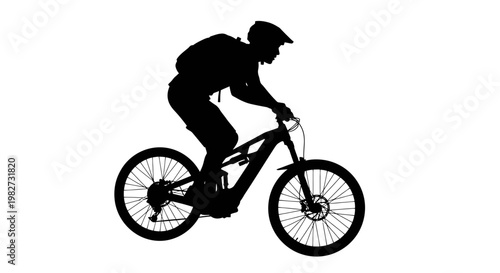 Silhouette of a mountain biker riding downhill on a trail