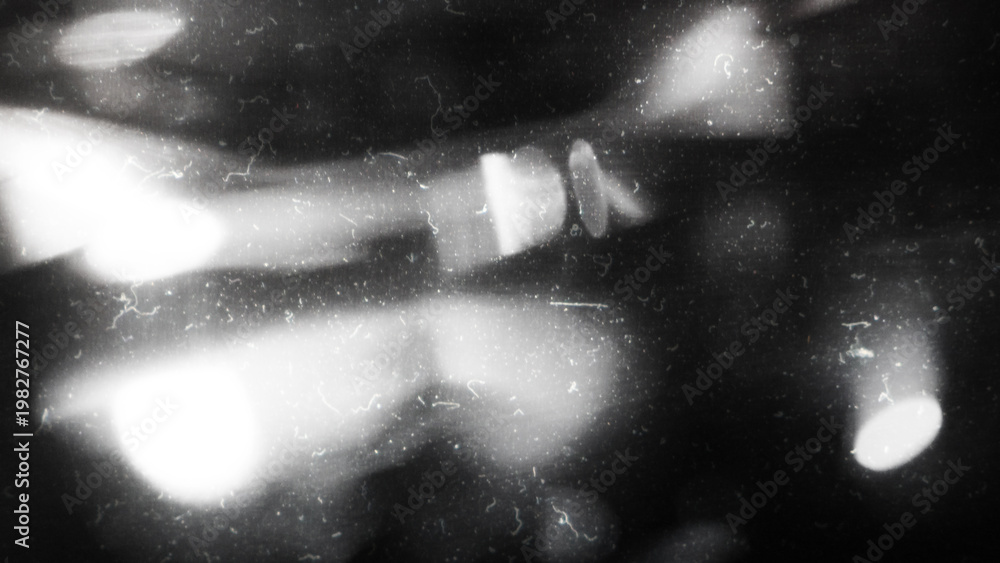 Obraz premium Old film texture with scratches, noise and light leaks. Realistic transparent overlay film texture in black-white, dust and grain. Distressed retro movie or photo negative effect of cinema nostalgia