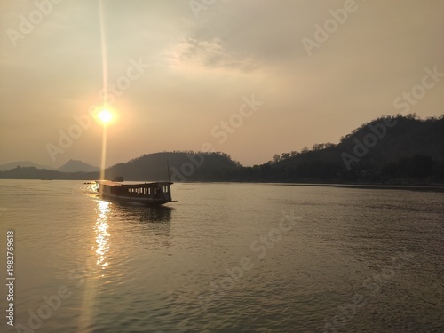 Traditional River Boat with Lao Flag and Mountain Landscape