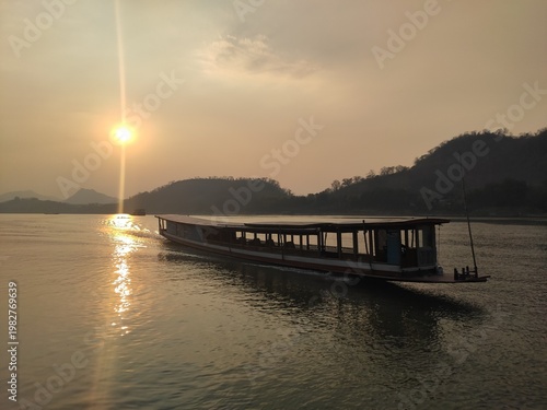 Traditional River Boat with Lao Flag and Mountain Landscape
