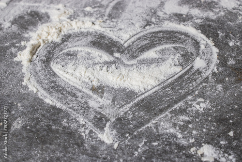 Obraz na płótnie A Heart Shaped Impression in Flour on a Rustic Surface, Symbolizing Love and Cul