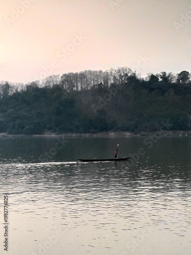 Traditional River Boat with Lao Flag and Mountain Landscape